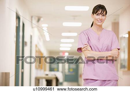 Stock Image - Nurse Standing In A Hospital Corridor. Fotosearch