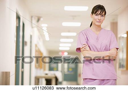 Stock Image - Nurse Standing In A Hospital Corridor. Fotosearch