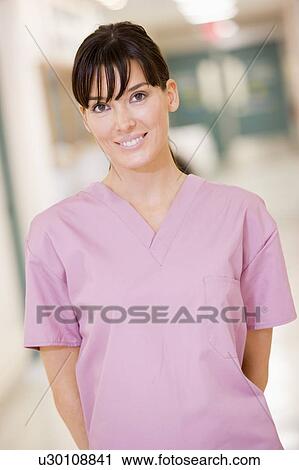 Stock Image - Nurse Standing In A Hospital Corridor. Fotosearch