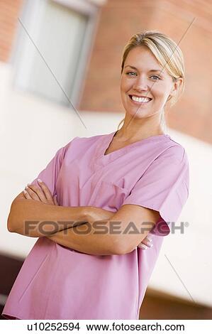 Nurse Standing Outside A Hospital View Large Photo Image Picture - Nurse Standing Outside A Hospital. Fotosearch