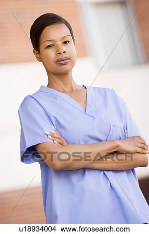 Nurse Standing Outside A Hospital View Large Photo Image Picture - Nurse Standing Outside A Hospital. Fotosearch