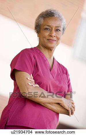 Picture - Nurse Standing Outside A Hospital. Fotosearch
