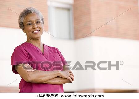 Stock Photo - Nurse Standing Outside A Hospital. Fotosearch