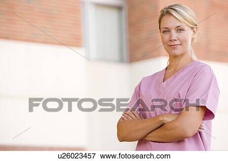 Nurse Standing Outside A Hospital View Large Photo Image Stock Photo - Nurse Standing Outside A Hospital. Fotosearch