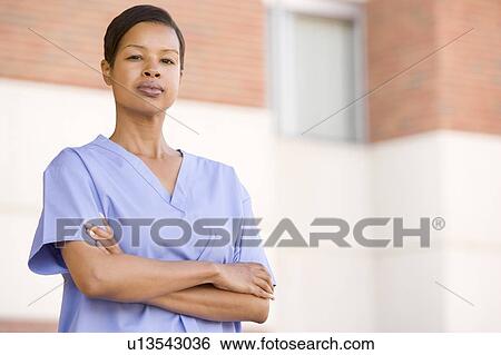 Stock Photograph - Nurse Standing Outside A Hospital. Fotosearch