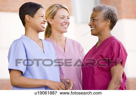 Nurses Standing Outside A Hospital View Large Photo Image Stock Photo - Nurses Standing Outside A Hospital. Fotosearch
