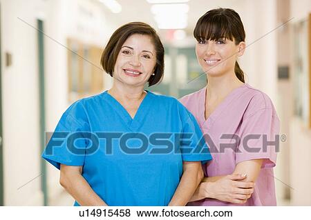 Two Female Nurses Standing In A Hospital Corridor View Large Photo Image Stock Photo - Two Female Nurses Standing In A Hospital Corridor. Fotosearch
