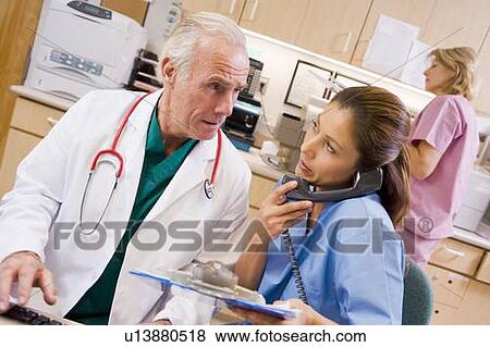 A Doctor And Nurse At The Reception Area Of A Hospital View Large Photo Image Stock Photo - A Doctor And Nurse At The Reception Area Of A Hospital. Fotosearch