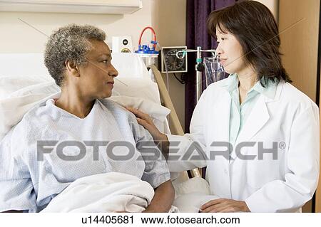 Stock Image - Doctor And Patient Looking At Each Other. Fotosearch
