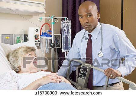 Doctor Checking Up On Patient, Looking Serious View Large Photo Image Stock Photo - Doctor Checking Up On Patient, Looking Serious. Fotosearch