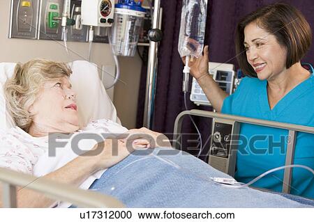 Stock Image - Doctor Checking Up On Senior Woman. Fotosearch