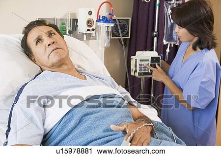 Stock Image - Doctor Helping Middle Aged Man. Fotosearch