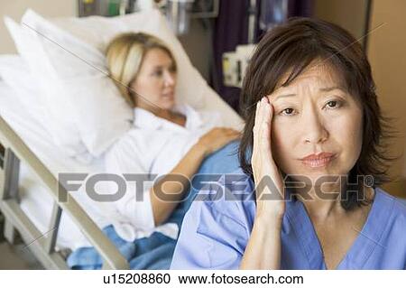 Stock Image - Doctor In Patients Room With Headache. Fotosearch