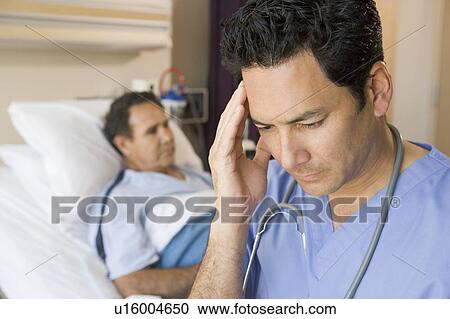Stock Image - Doctor Looking Frustrated In Patients Room. Fotosearch