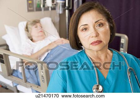 Stock Image - Doctor Looking Serious In Patients Room. Fotosearch