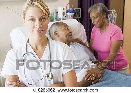 Stock Image - Doctor Standing In Hospital Room With Her Arms Folded. Fotosearch