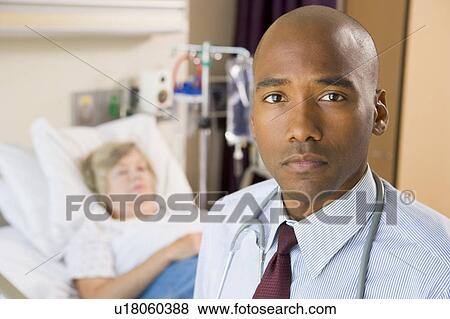Stock Photo - Doctor Standing In Patients Room. Fotosearch
