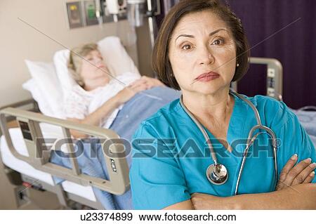 Doctor Standing With Arms Crossed In Patients Room View Large Photo Image Stock Photo - Doctor Standing With Arms Crossed In Patients Room. Fotosearch