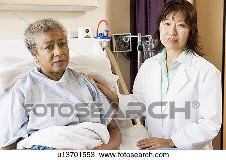 Stock Image - Doctor Talking To Senior Woman. Fotosearch