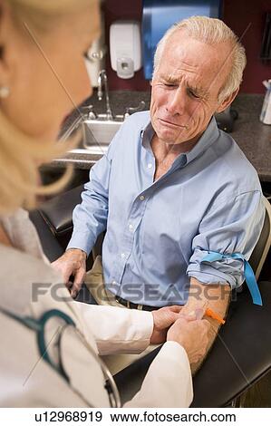 Stock Photo - Middle Aged Man Having Blood Test Done. Fotosearch