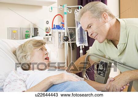 Middle Aged Man Talking To Senior Woman In Hospital View Large Photo Image Stock Image - Middle Aged Man Talking To Senior Woman In Hospital. Fotosearch