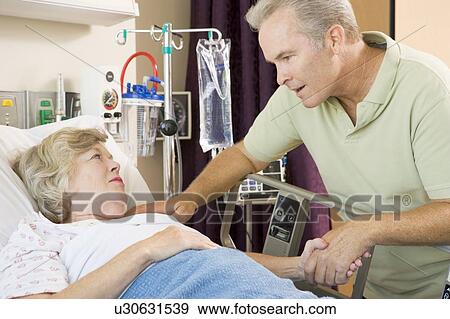 Middle Aged Man Visiting His Mother In Hospital View Large Photo Image Stock Photo - Middle Aged Man Visiting His Mother In Hospital. Fotosearch