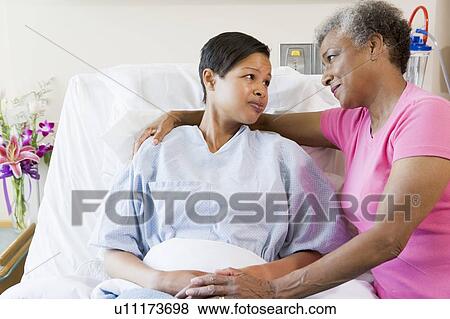 Stock Photo - Mother And Daughter Looking At Each Other In Hospital. Fotosearch