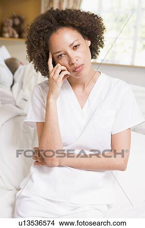 Nurse Sitting On Hospital Bed View Large Photo Image Picture - Nurse Sitting On Hospital Bed. Fotosearch
