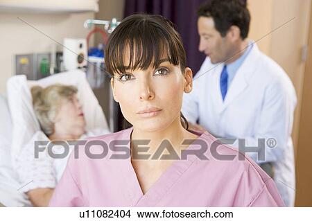 Nurse Standing In Hospital Room, Doctor Talking To Patient View Large Photo Image Picture - Nurse Standing In Hospital Room, Doctor Talking To Patient. Fotosearch