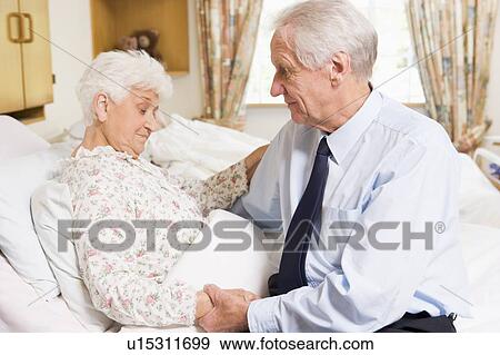 Stock Photo - Senior Man Visiting His Wife In Hospital. Fotosearch