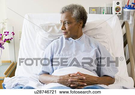 Stock Image - Senior Woman Sitting In Hospital Bed. Fotosearch