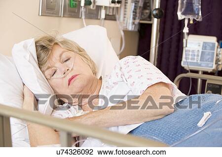 Stock Image - Senior Woman Sleeping In Hospital Bed. Fotosearch