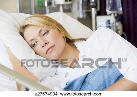Picture - Woman Lying Down In Hospital Bed. Fotosearch