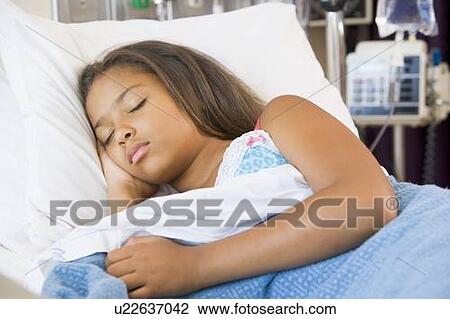 Stock Image - Young Girl Sleeping In Hospital Bed. Fotosearch