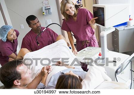 Doctor looking at monitor while retrieving eggs from ovary using vaginal ultrasound View Large Photo Image Stock Photo - Doctor looking at monitor while retrieving eggs from ovary using vaginal ultrasound. Fotosearch
