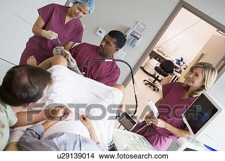 Picture - Doctor retrieving eggs from ovary using vaginal ultrasound. Fotosearch