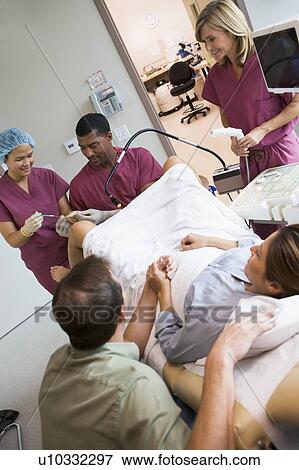 Stock Photo - Doctor retrieving eggs from ovary using vaginal ultrasound. Fotosearch
