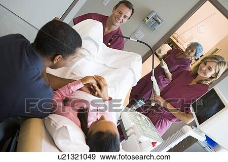 Stock Photo - Doctor retrieving eggs from ovary using vaginal ultrasound. Fotosearch