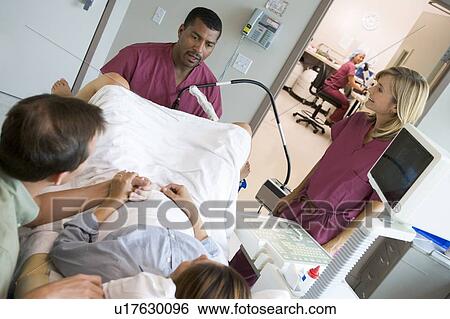 Stock Photograph - Doctor retrieving eggs from ovary using vaginal ultrasound. Fotosearch