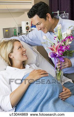 Man Giving His Pregnant Wife Flowers View Large Photo Image Stock Photo - Man Giving His Pregnant Wife Flowers. Fotosearch