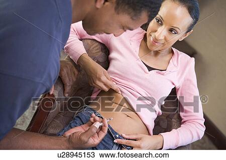Stock Image - Man helping woman inject drugs to gain pregnancy (selective focus). Fotosearch