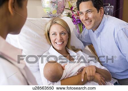 New parents with baby talking to doctor and smiling View Large Photo Image Stock Image - New parents with baby talking to doctor and smiling. Fotosearch