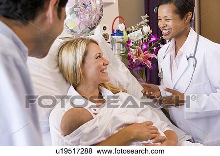 New parents with baby talking to doctor and smiling View Large Photo Image Stock Photo - New parents with baby talking to doctor and smiling. Fotosearch