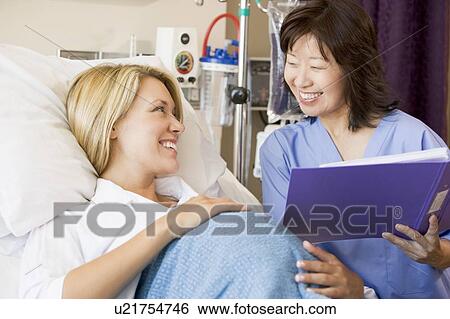Stock Photograph - Pregnant Woman Talking To Doctor. Fotosearch