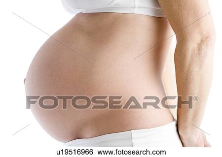 Stock Photograph - Pregnant woman's exposed belly. Fotosearch