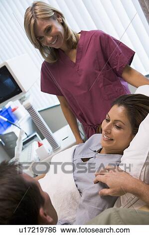 Stock Photograph - Woman having eggs retrieved from ovary using vaginal ultrasound. Fotosearch