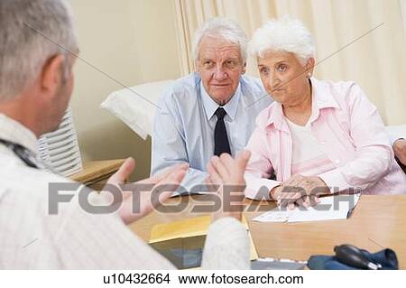 Picture - Couple in doctor's office frowning. Fotosearch
