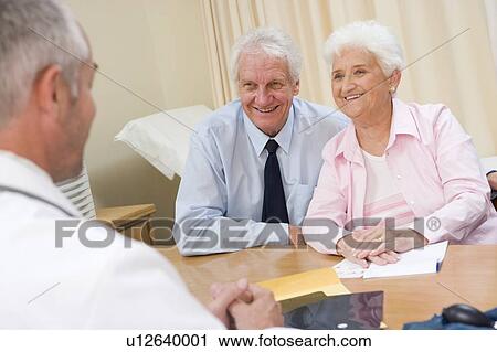 Couple in doctor's office smiling View Large Photo Image Stock Image - Couple in doctor's office smiling. Fotosearch