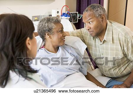 Doctor Explaining, Senior Couple Looking At Each Other View Large Photo Image Stock Photograph - Doctor Explaining, Senior Couple Looking At Each Other. Fotosearch