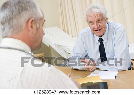 Man in doctor's office smiling View Large Photo Image Stock Photo - Man in doctor's office smiling. Fotosearch